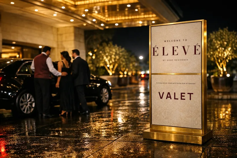 Valet signage — A limestone and brass valet sign at the hotel porte-cochère