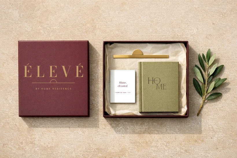 Take-away gift — A burgundy keepsake box with a brass-foil ÉLEVÉ lid